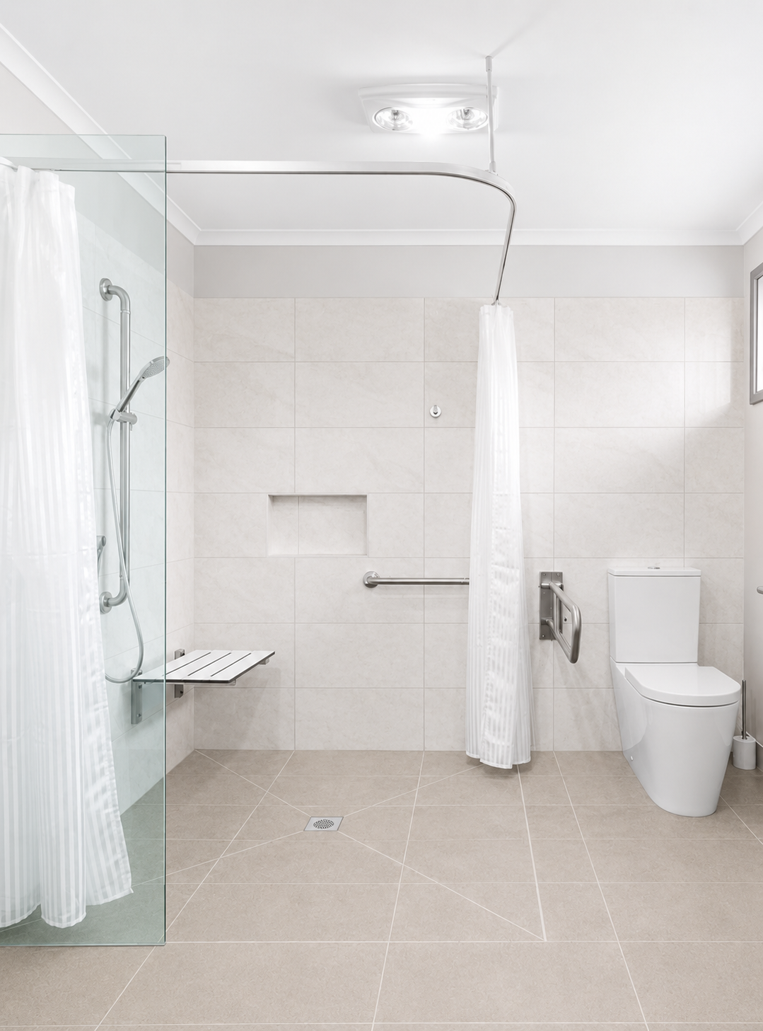 Accessible bathroom with a level-access shower, fold-down seat, grab rails and a step-free tiled floor.